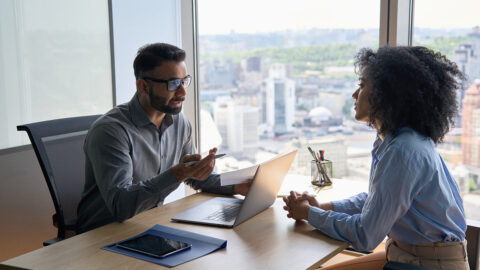 Two people speaking during an interview