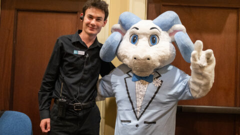 A student employee at Carolina Performing Arts with Rameses the UNC mascot